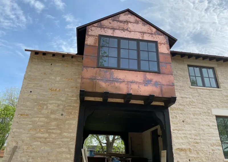 Copper metal panel facade on a stone building for Skylight Installation in Robbinsdale