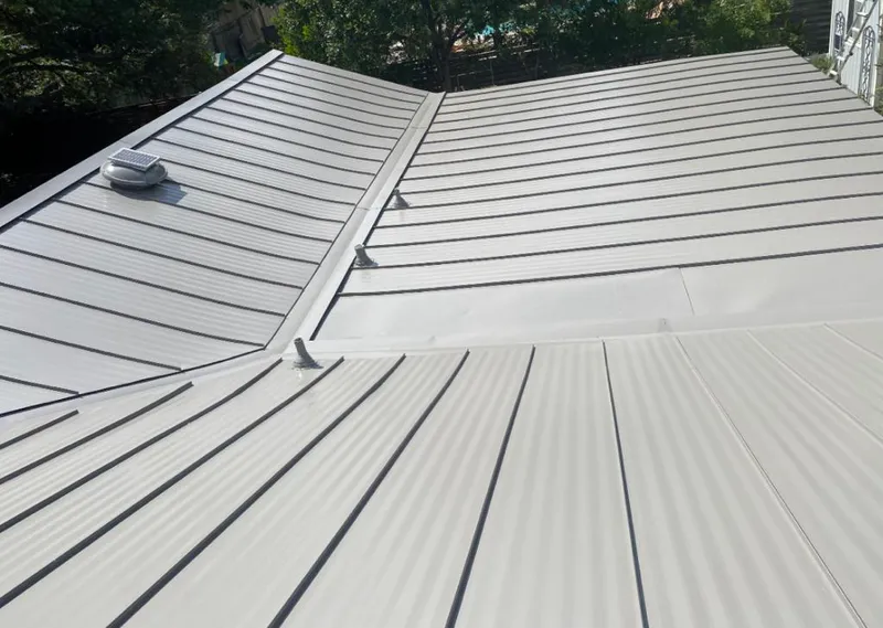 Solar attic fan installed on a metal roof for Roof Ventilation in Robbinsdale